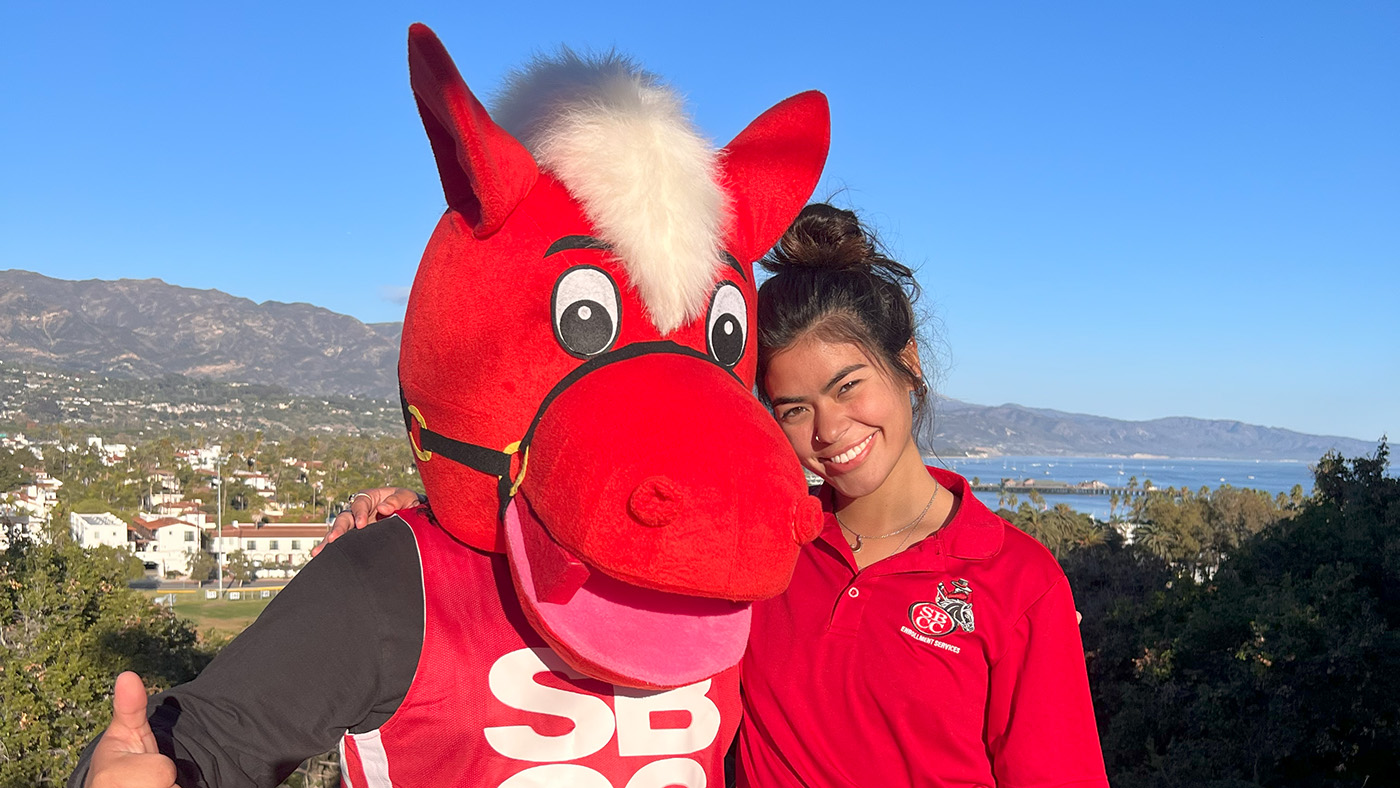 Red and a student worker posing for a photo